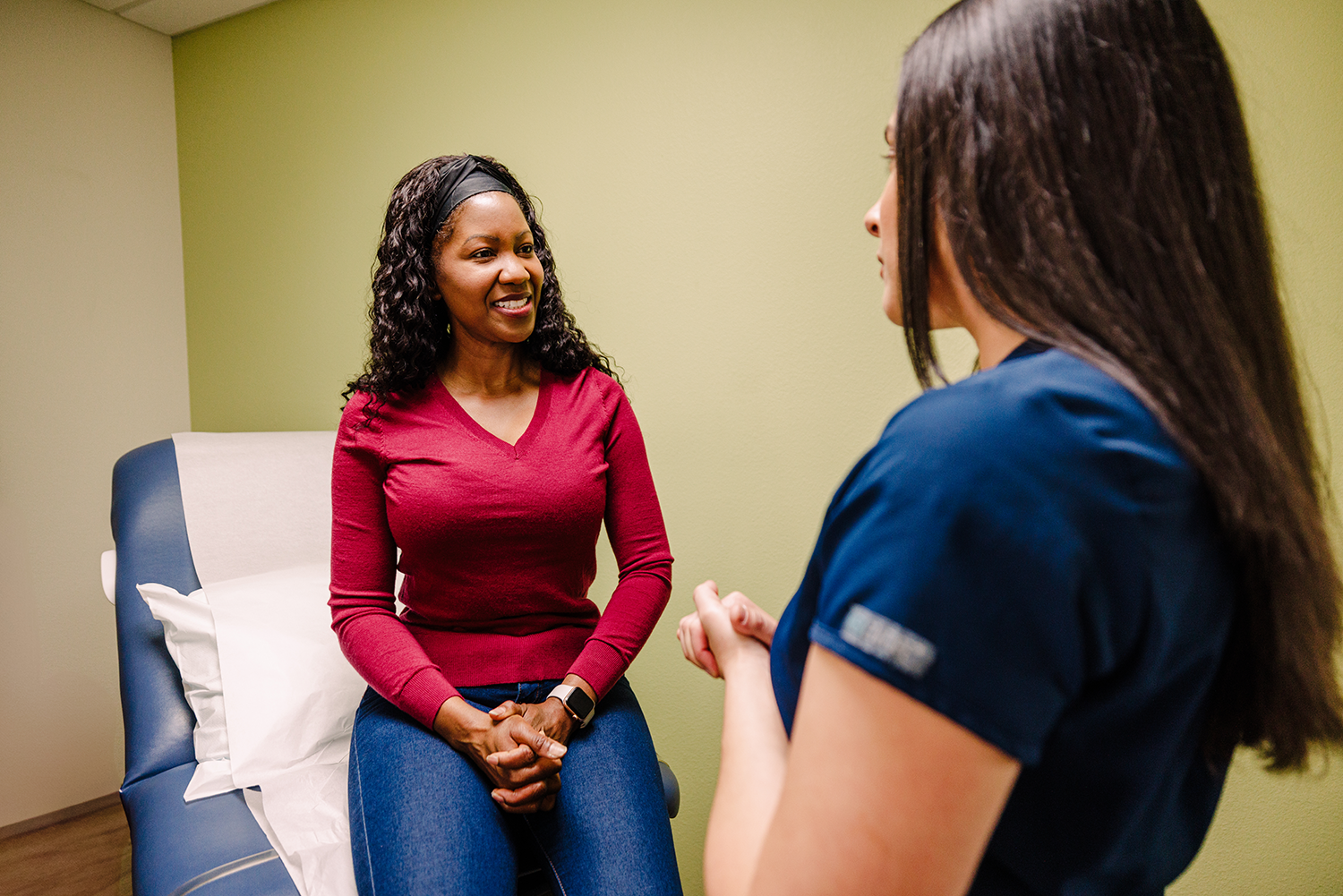 Female patient talking to a female Urology Nevada provider in exam room